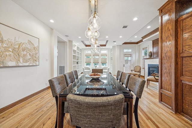 1010 Cortlandt St, Houston, TX 77008 - dining space with light wood finished floors, baseboards, a fireplace, recessed lighting, and a chandelier