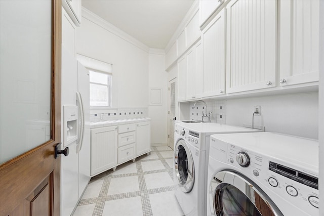 1010 Cortlandt St, Houston, TX 77008 - laundry area with washing machine and dryer, cabinet space, crown molding, and light flooring