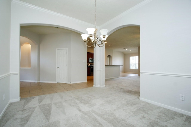 2414 Hannover Valley Ct, Spring, TX 77388 - carpeted empty room featuring arched walkways, a chandelier, ornamental molding, and baseboards