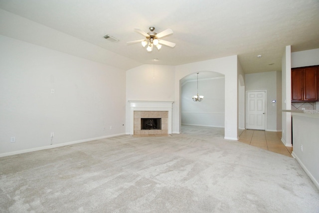 2414 Hannover Valley Ct, Spring, TX 77388 - unfurnished living room with light carpet, ceiling fan, arched walkways, a fireplace, and baseboards