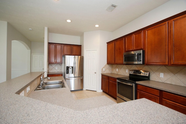 2414 Hannover Valley Ct, Spring, TX 77388 - kitchen featuring stainless steel appliances, a sink, tasteful backsplash, recessed lighting, and light tile patterned floors