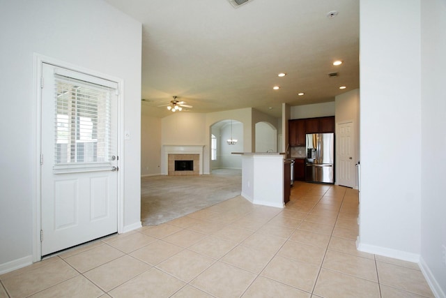 2414 Hannover Valley Ct, Spring, TX 77388 - unfurnished living room with arched walkways, a ceiling fan, light tile patterned flooring, recessed lighting, and baseboards
