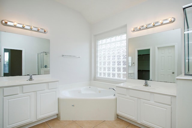 2414 Hannover Valley Ct, Spring, TX 77388 - full bath featuring tile patterned floors, a shower stall, lofted ceiling, a garden tub, and two vanities