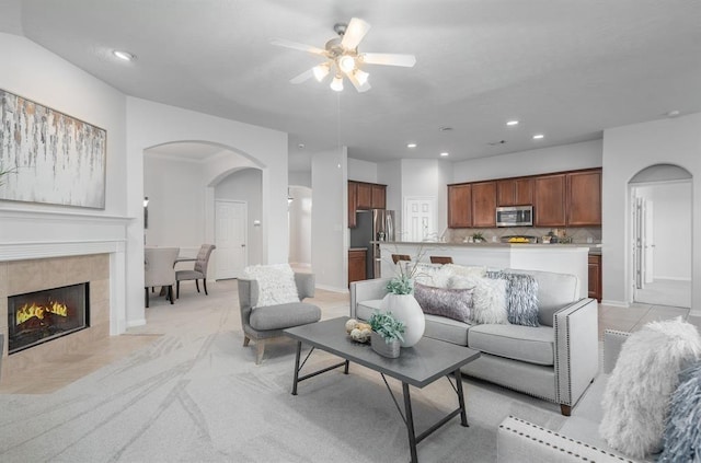 2414 Hannover Valley Ct, Spring, TX 77388 - living room featuring arched walkways, a ceiling fan, recessed lighting, baseboards, and a tile fireplace