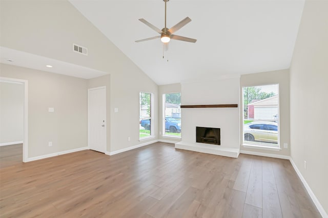 6334 Cambridge Glen Ln, Houston, TX 77035 - unfurnished living room featuring healthy amount of natural light, high vaulted ceiling, light wood finished floors, and baseboards