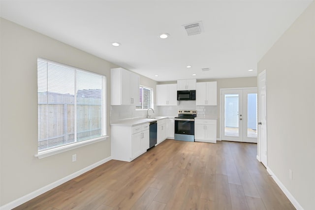 6334 Cambridge Glen Ln, Houston, TX 77035 - kitchen featuring electric stove, black microwave, dishwashing machine, a sink, and light countertops