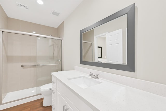 6334 Cambridge Glen Ln, Houston, TX 77035 - full bathroom featuring toilet, a stall shower, vanity, and wood finished floors