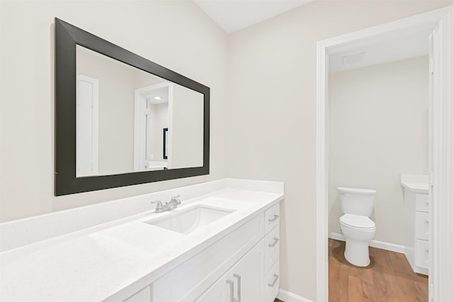 6334 Cambridge Glen Ln, Houston, TX 77035 - bathroom featuring baseboards, toilet, wood finished floors, and vanity