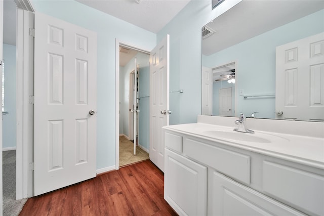 16655 Millridge Ln, Houston, TX 77095 - bathroom featuring vanity, wood finished floors, ceiling fan, and baseboards
