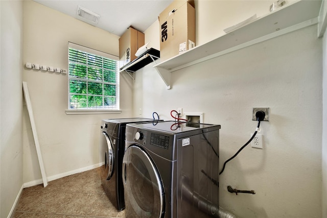 16655 Millridge Ln, Houston, TX 77095 - laundry room with independent washer and dryer, baseboards, and light tile patterned floors