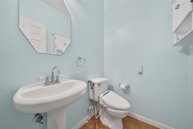 16655 Millridge Ln, Houston, TX 77095 - bathroom with baseboards, toilet, and tile patterned floors
