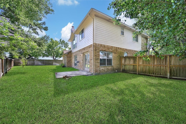16655 Millridge Ln, Houston, TX 77095 - back of property featuring a chimney, brick siding, and a patio area