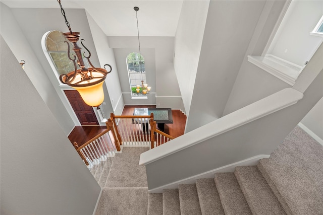 3427 Powell Way, Missouri City, TX 77459 - stairway featuring carpet, a chandelier, baseboards, and lofted ceiling