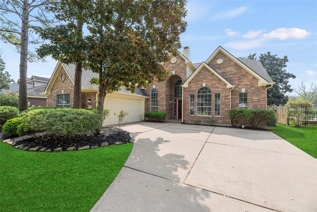 3427 Powell Way, Missouri City, TX 77459 - traditional home featuring concrete driveway, brick siding, a chimney, and a garage