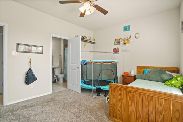 22078 Sun Haven Ln, Porter, TX 77365 - bedroom with carpet floors, connected bathroom, baseboards, and a ceiling fan