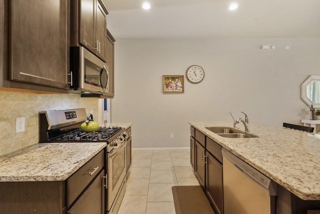 22078 Sun Haven Ln, Porter, TX 77365 - kitchen featuring stainless steel appliances, a sink, tasteful backsplash, dark brown cabinets, and recessed lighting