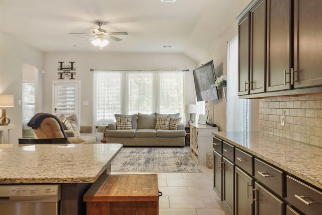 22078 Sun Haven Ln, Porter, TX 77365 - kitchen with ceiling fan, dishwasher, tasteful backsplash, light tile patterned floors, and light stone countertops