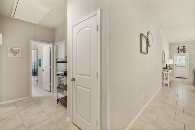 22078 Sun Haven Ln, Porter, TX 77365 - hallway with attic access, light tile patterned floors, and baseboards