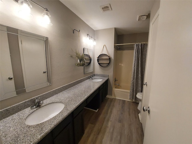 2356 Gemini St, Houston, TX 77058 - full bath featuring wood finished floors, toilet, shower / tub combo with curtain, and double vanity
