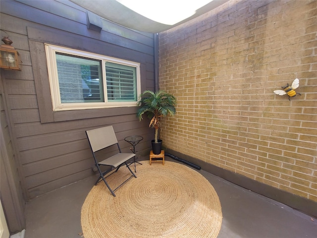 2356 Gemini St, Houston, TX 77058 - living area with concrete floors, brick wall, and wood walls