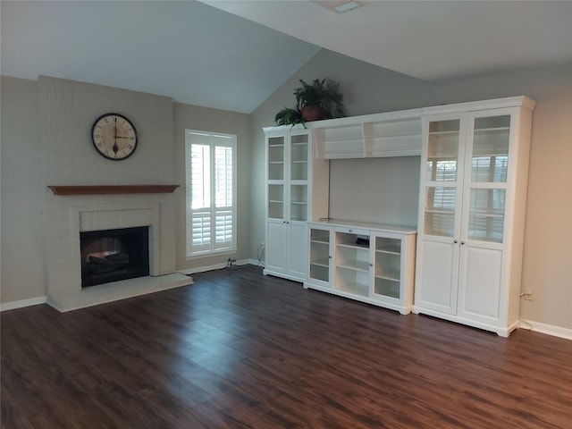 2356 Gemini St, Houston, TX 77058 - unfurnished living room featuring vaulted ceiling, dark wood-type flooring, baseboards, and a brick fireplace