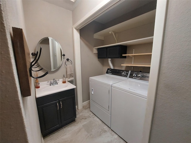 2356 Gemini St, Houston, TX 77058 - clothes washing area with washing machine and dryer, cabinet space, and light marble finish floors