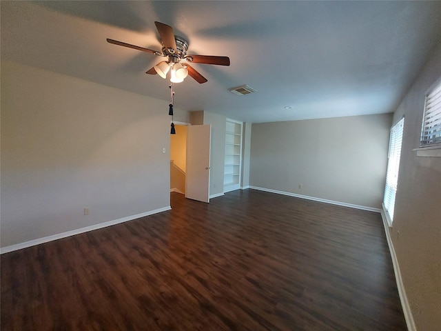2356 Gemini St, Houston, TX 77058 - spare room with built in shelves, baseboards, dark wood finished floors, and ceiling fan
