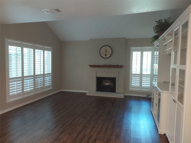 2356 Gemini St, Houston, TX 77058 - unfurnished living room featuring dark wood-style floors, a fireplace with raised hearth, vaulted ceiling, and baseboards