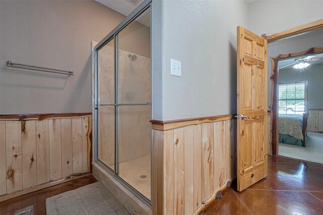 16325 Senkel Rd, East Bernard, TX 77435 - full bathroom with a shower stall, a wainscoted wall, ensuite bath, wood walls, and finished concrete floors