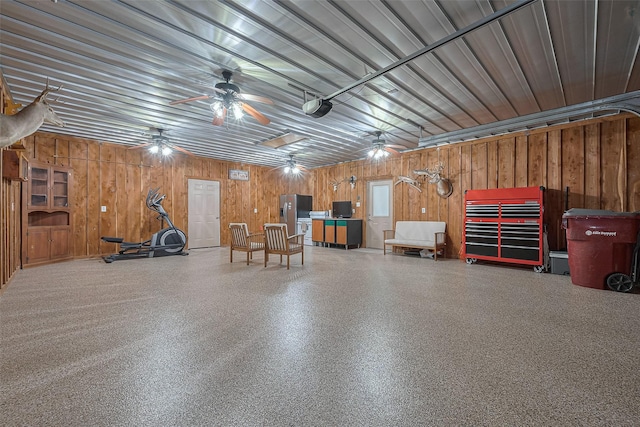 16325 Senkel Rd, East Bernard, TX 77435 - garage featuring stainless steel refrigerator with ice dispenser, wood walls, a ceiling fan, and a garage door opener