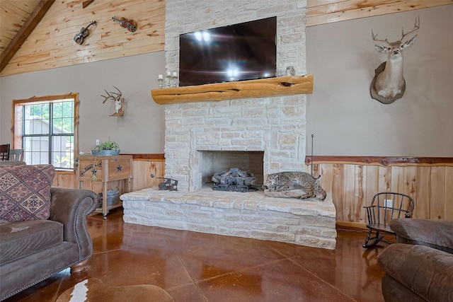 16325 Senkel Rd, East Bernard, TX 77435 - living area with wooden walls, wainscoting, concrete floors, wood ceiling, and a fireplace