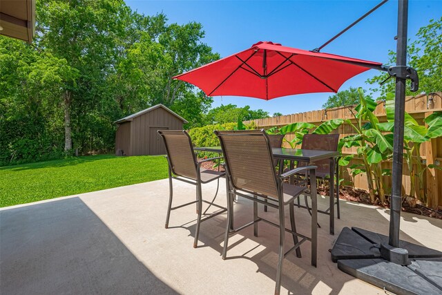 16325 Senkel Rd, East Bernard, TX 77435 - view of patio / terrace with a shed, outdoor dining space, and an outdoor structure