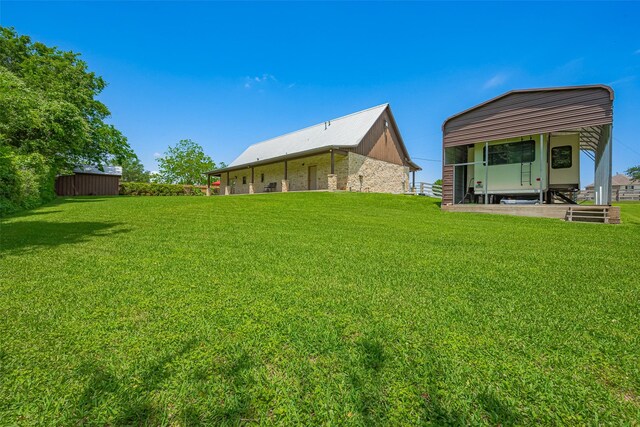 16325 Senkel Rd, East Bernard, TX 77435 - rear view of house featuring a lawn and a detached carport