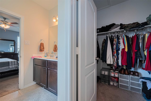 10027 Yanet Grove Ln, Houston, TX 77044 - ensuite bathroom featuring ceiling fan, a spacious closet, tile patterned flooring, and vanity