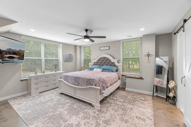 4439 W Bayshore Rd, Anahuac, TX 77514 - bedroom with a barn door, baseboards, a ceiling fan, and recessed lighting