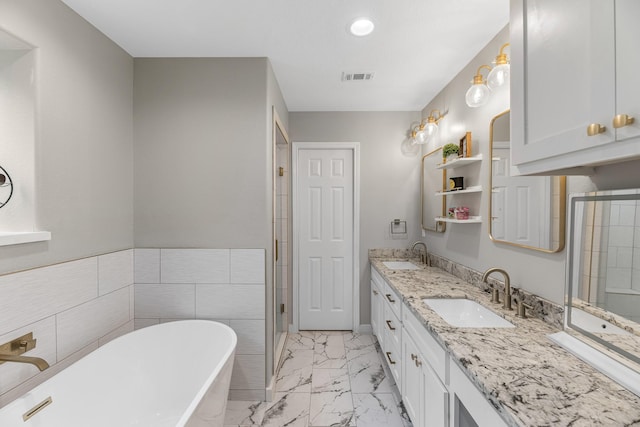4439 W Bayshore Rd, Anahuac, TX 77514 - bathroom featuring a soaking tub, marble finish flooring, double vanity, recessed lighting, and a shower stall