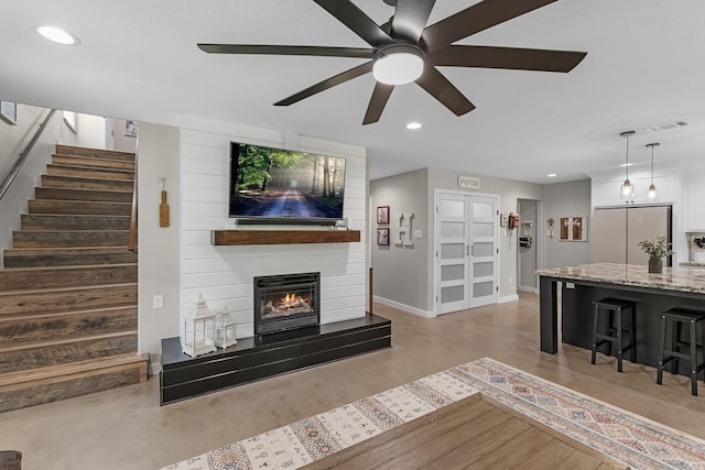 4439 W Bayshore Rd, Anahuac, TX 77514 - living room featuring stairway, recessed lighting, ceiling fan, baseboards, and a large fireplace