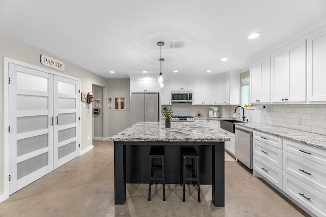 4439 W Bayshore Rd, Anahuac, TX 77514 - kitchen with appliances with stainless steel finishes, a sink, finished concrete flooring, decorative backsplash, and recessed lighting