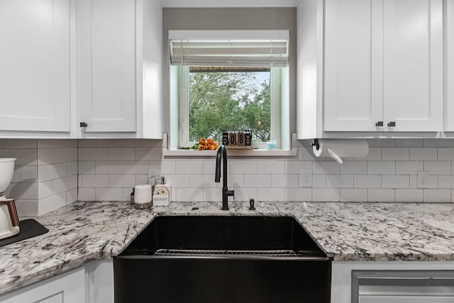 4439 W Bayshore Rd, Anahuac, TX 77514 - kitchen with a sink, white cabinetry, decorative backsplash, and light stone counters