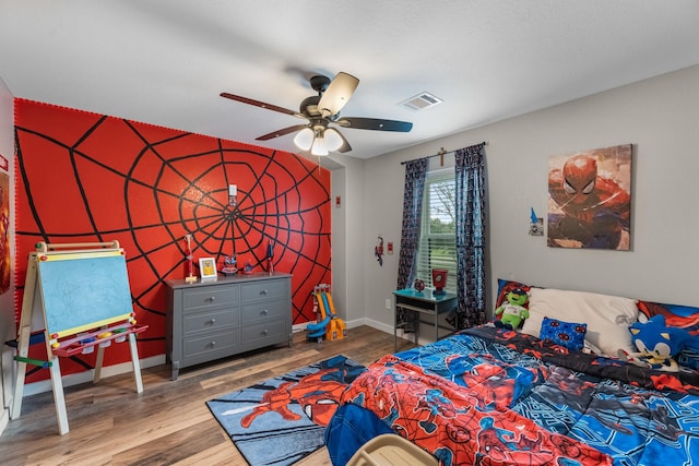4439 W Bayshore Rd, Anahuac, TX 77514 - bedroom featuring baseboards, wood finished floors, and ceiling fan
