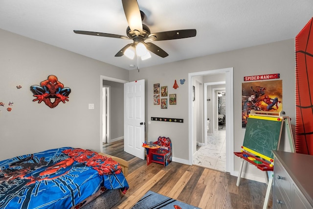 4439 W Bayshore Rd, Anahuac, TX 77514 - bedroom featuring wood finished floors, baseboards, and a ceiling fan