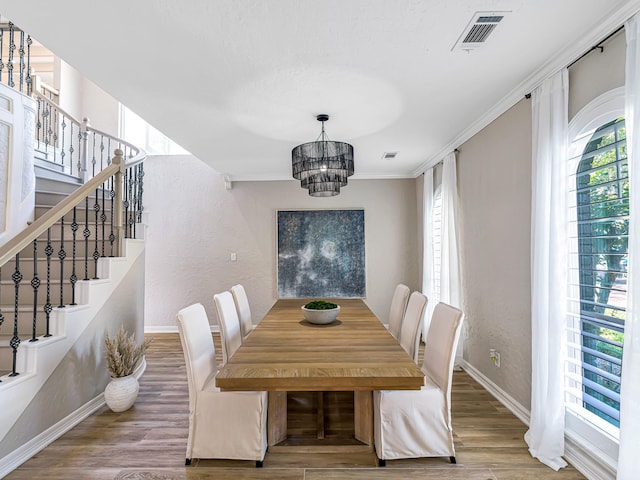 20647 Laurel Lock Dr, Katy, TX 77450 - dining space featuring baseboards, a chandelier, stairs, a textured wall, and crown molding