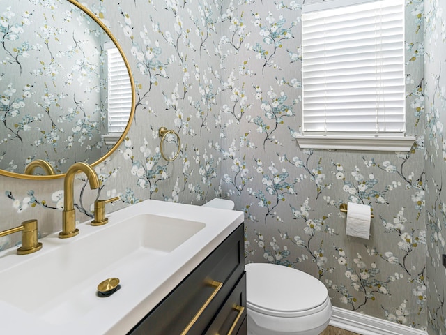 20647 Laurel Lock Dr, Katy, TX 77450 - half bathroom featuring wallpapered walls, vanity, healthy amount of natural light, toilet, and baseboards