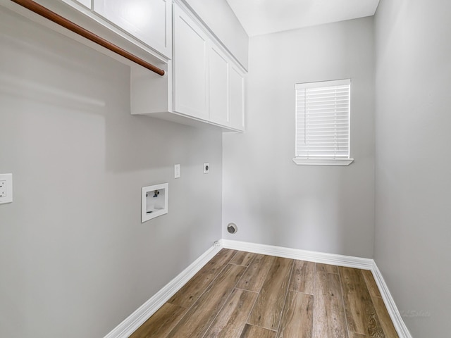 20647 Laurel Lock Dr, Katy, TX 77450 - laundry room with cabinet space, hookup for a washing machine, wood finished floors, baseboards, and hookup for an electric dryer