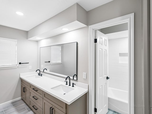 20647 Laurel Lock Dr, Katy, TX 77450 - bathroom with double vanity, recessed lighting, baseboards, and tub / shower combination