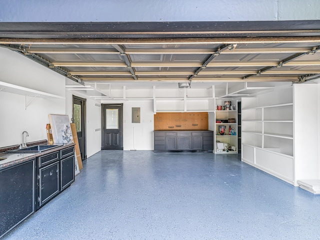 20647 Laurel Lock Dr, Katy, TX 77450 - garage featuring a sink, electric panel, and a garage door opener