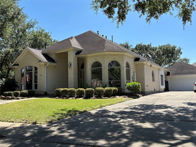 2331 Scottsdale Ct, League City, TX 77573 - view of front of home with brick siding, a front yard, driveway, and roof with shingles