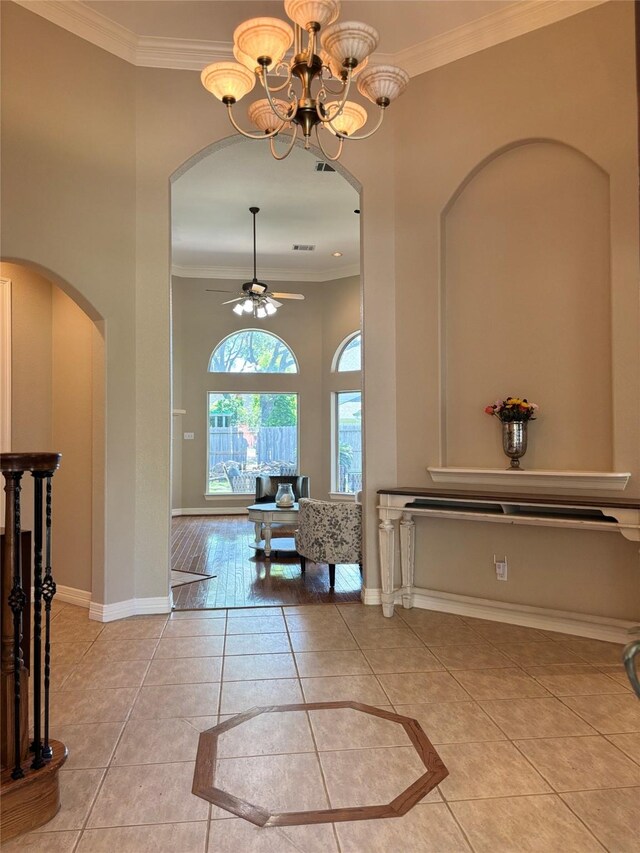 2331 Scottsdale Ct, League City, TX 77573 - entrance foyer with arched walkways, light tile patterned floors, a ceiling fan, ornamental molding, and baseboards
