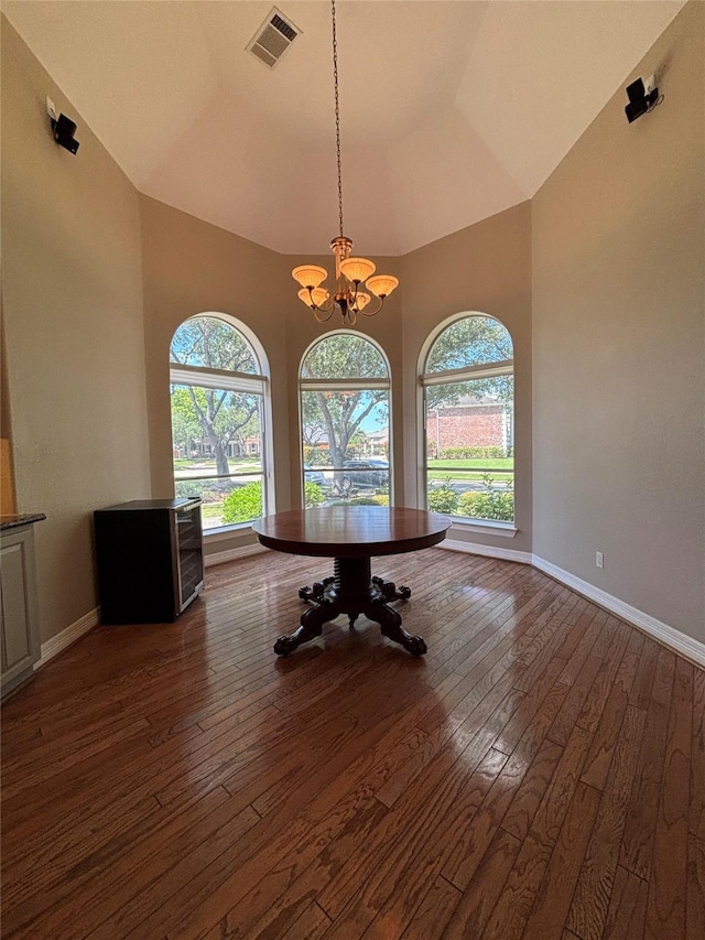 2331 Scottsdale Ct, League City, TX 77573 - dining area with hardwood / wood-style flooring, a chandelier, baseboards, and a high ceiling