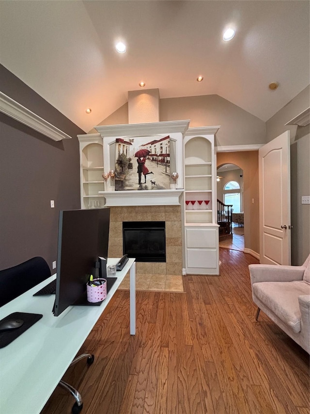 2331 Scottsdale Ct, League City, TX 77573 - office space with vaulted ceiling, wood finished floors, arched walkways, and a fireplace